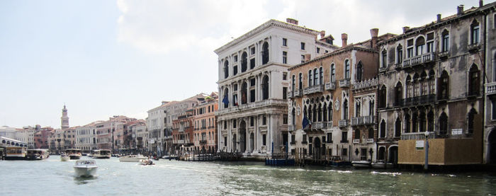 Boats in river with buildings in background