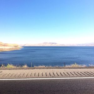 Scenic view of sea against clear blue sky