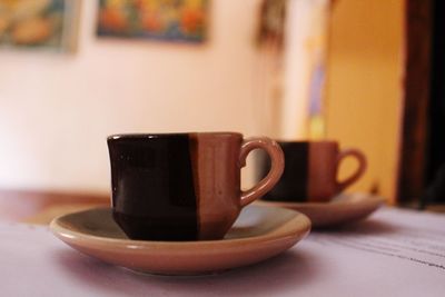 Close-up of coffee cup on table