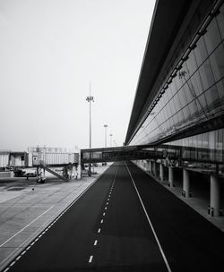 Empty road at airport against clear sky