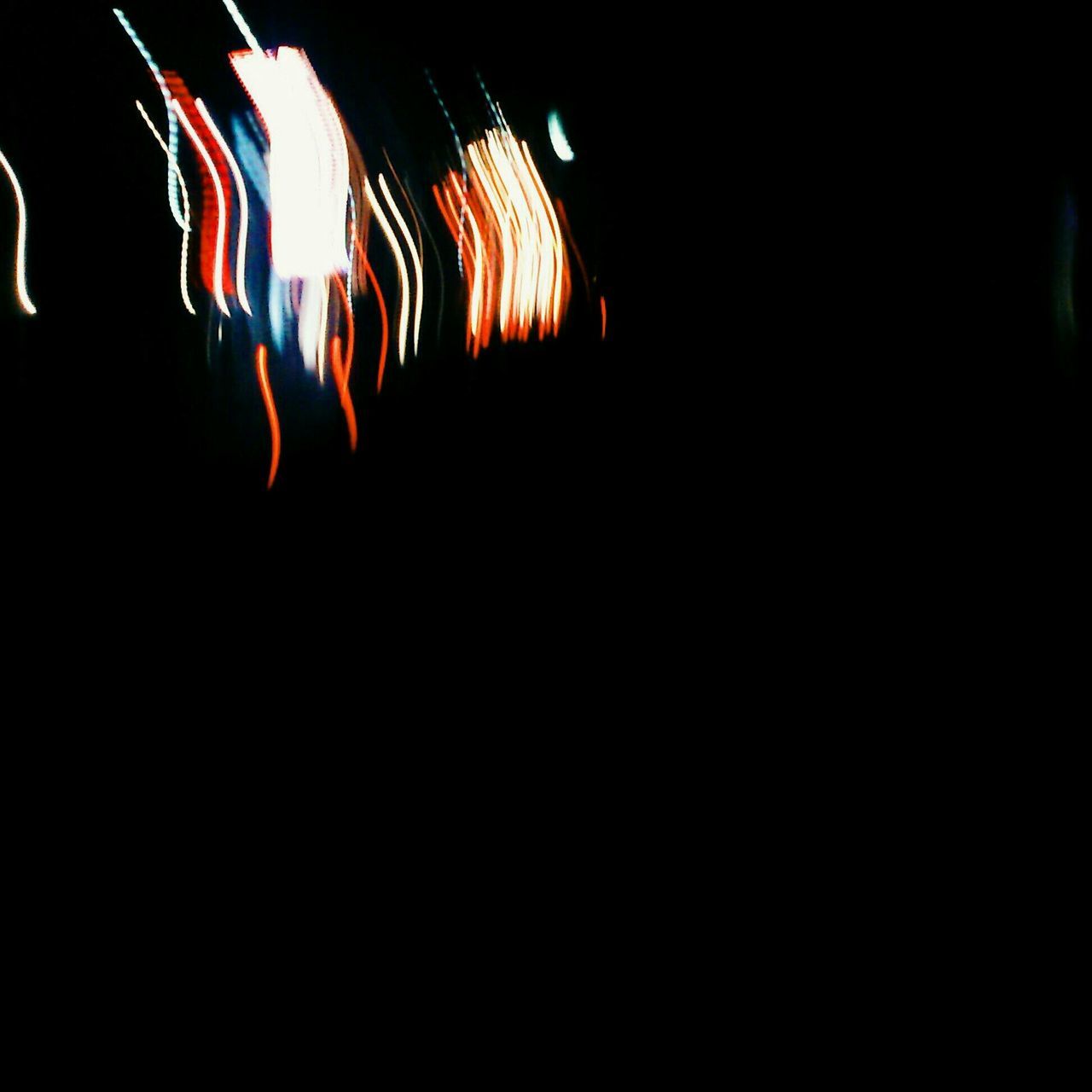 night, illuminated, dark, indoors, glowing, light - natural phenomenon, arts culture and entertainment, light, lighting equipment, copy space, celebration, multi colored, long exposure, motion, no people, burning, black background, event, lit, light effect