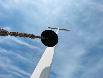 Low angle view of street light against cloudy sky