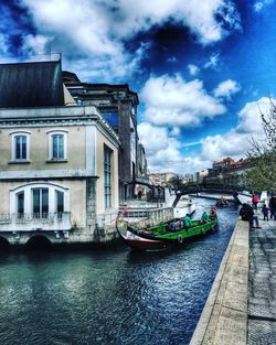 View of canal against cloudy sky