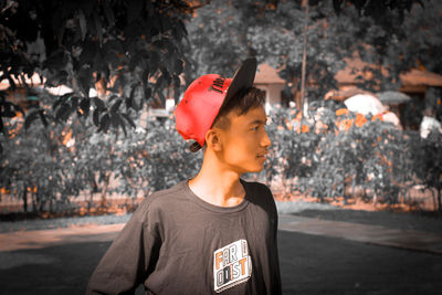 Portrait of young man looking away outdoors