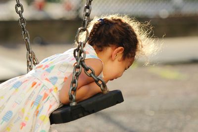 Close-up of girl with swing