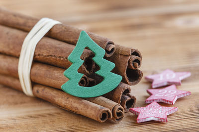 Bundle of cinnamon sticks with christmas decoration on table