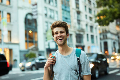 Portrait of smiling young man in city