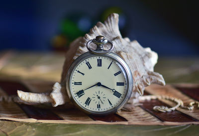 Close-up of pocket watch on table