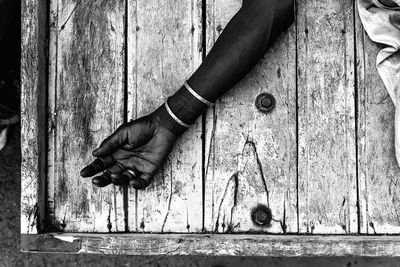 Close-up of hands on wood