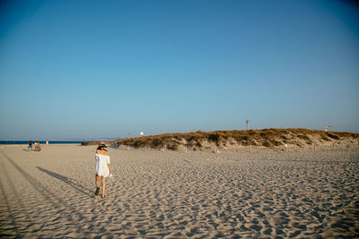 Full length of woman standing on beach