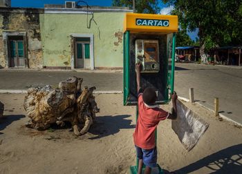 Rear view of man standing on street in city