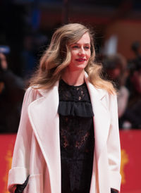 Portrait of smiling young woman standing outdoors