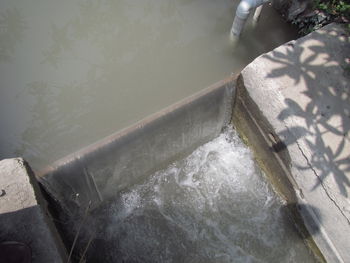 High angle view of water flowing over lake