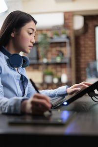 Side view of businesswoman working at home