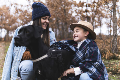 Young woman with dog wearing hat