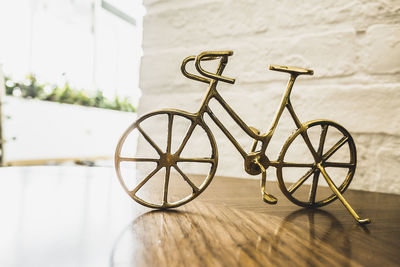 Bicycle on table against wall