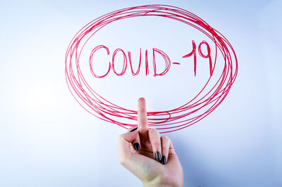 Midsection of person holding umbrella against white background