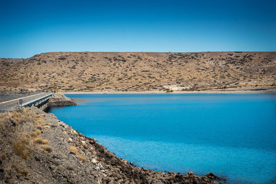 Scenic view of sea against clear blue sky