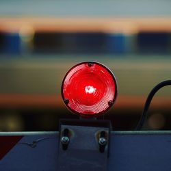 Close-up of road reflector on barricade