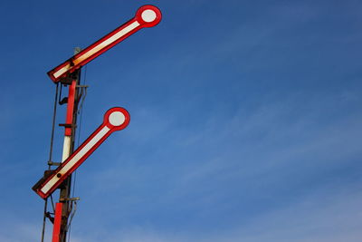 Low angle view of red wall against blue sky