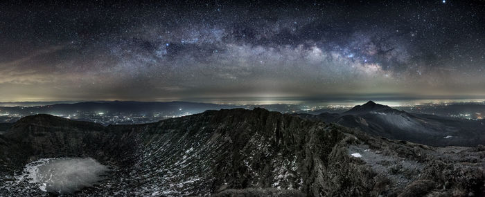 Scenic view of mountains against sky at night