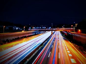 High angle view of light trails on highway at night