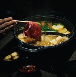 Cropped hand preparing food in kitchen