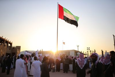 United arab emirates flag against clear sky during al janadriyah festival