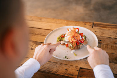 High angle view of woman holding ice cream on table