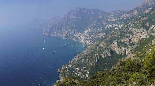 High angle view of sea and mountains against sky