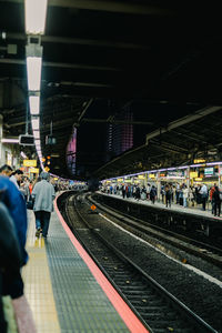People waiting at railroad station platform