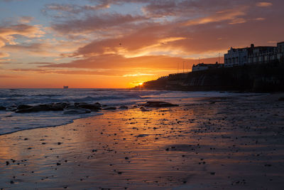 Seascape against cloudy sky at dusk