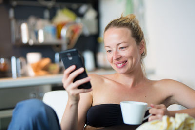 Midsection of woman using mobile phone