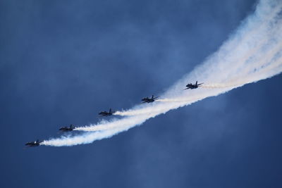 Low angle view of airplane flying against sky