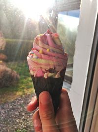 Close-up of hand holding ice cream cone