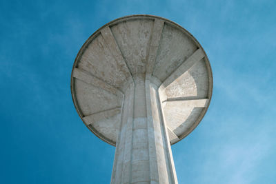 Tower of the aqueduct against blue sky, brutalist architecture