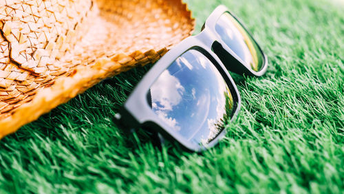 High angle view of sunglasses on grassy field