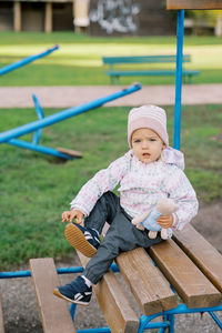 Portrait of boy sitting on bench