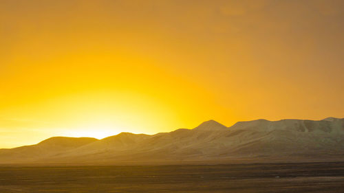 Barren landscape against the sky