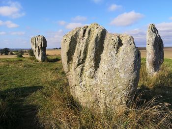 Panoramic view of rocks on field against sky