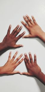 Close-up of hands over white background