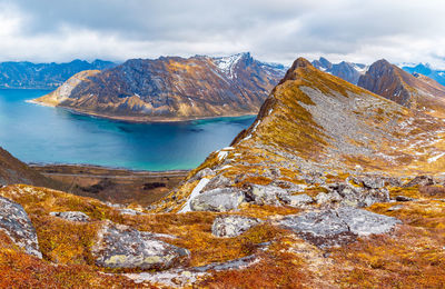 Scenic view of lake and mountains against sky