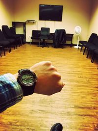 Midsection of man sitting on table at home