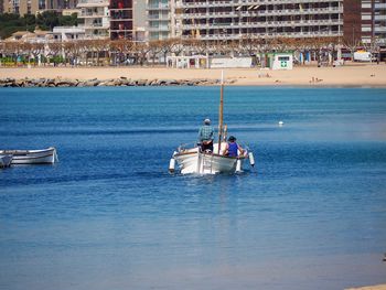 Boat in sea against city