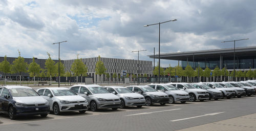 Cars in parking lot against sky