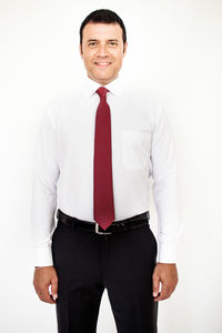 Portrait of smiling man standing against white background