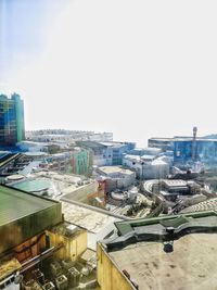 Buildings in city against clear sky