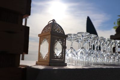 Close-up of lantern on table against sky