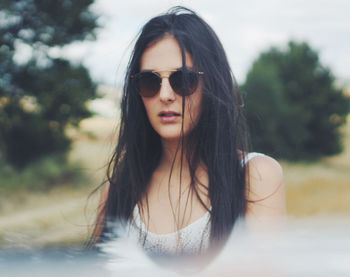 Young girl with sunglasses in the field