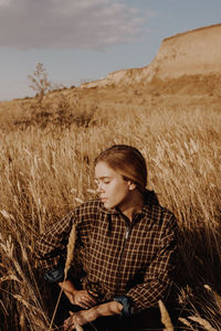 Young woman sitting on field